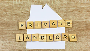 wooden table with Private Landlord spelled out in scrabble letters