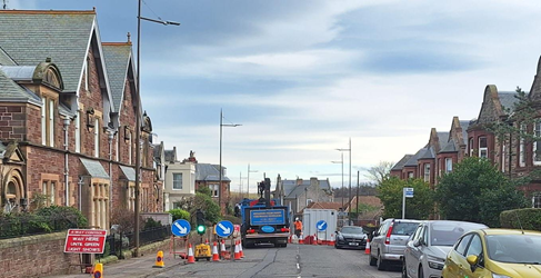 Road traffic management and parked cars shown on a residential street