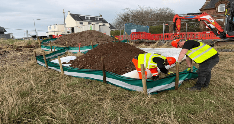 Two men at work wearing PPE on a construction site