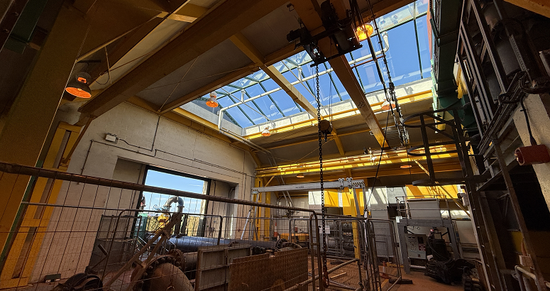 The newly paved walkway at the perimeter of the site of works at Esk Waste Water Pumping Station in Musselburgh is shown. The works are adjacent to a playing field.