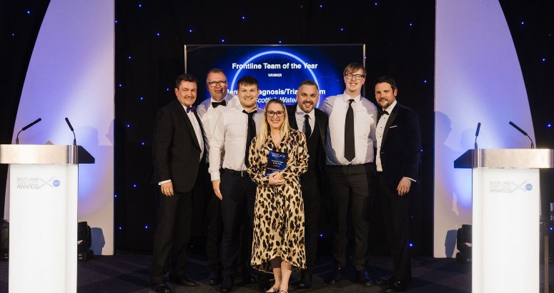 Image of seven people proudly holding award