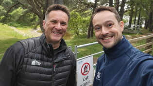 Ranger Josh taking a selfie with David Main from Scottish Fire and Rescue. Gladhouse woodland in background as well as a no fire sign.
