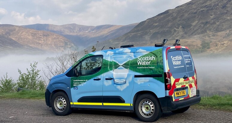 A Scottish Water branded small van in front of a beautiful mountain backdrop on road near to Fort William