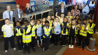     Group photo of Dunard Primary Children, teacher Mr Montgomery, Glasgow Science Centre reps Gillian Land and Joe Oxley - Gleister, Alex plant and Lorna Neilson standing beside water exhibit at Glasgow Science Centre.