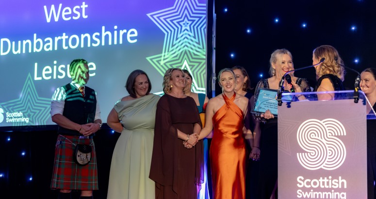 The members of West Dunbartonshire Leisure are photographed collecting their award on stage with one lady from the team being interviewed.