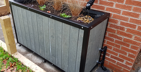 example of a planter installed on a property to capture roof run off