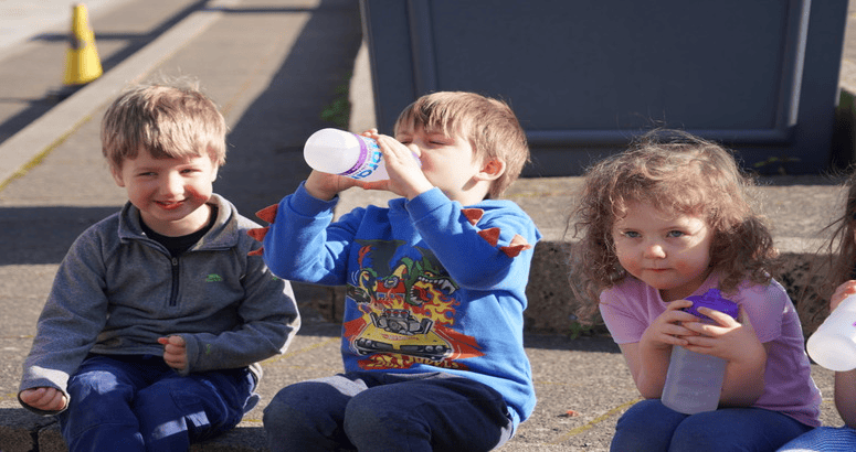 Nursery children enjoying tap water