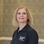 Head and shoulders of Scottish Water director of people, wearing a Scottish Water branded polo top.